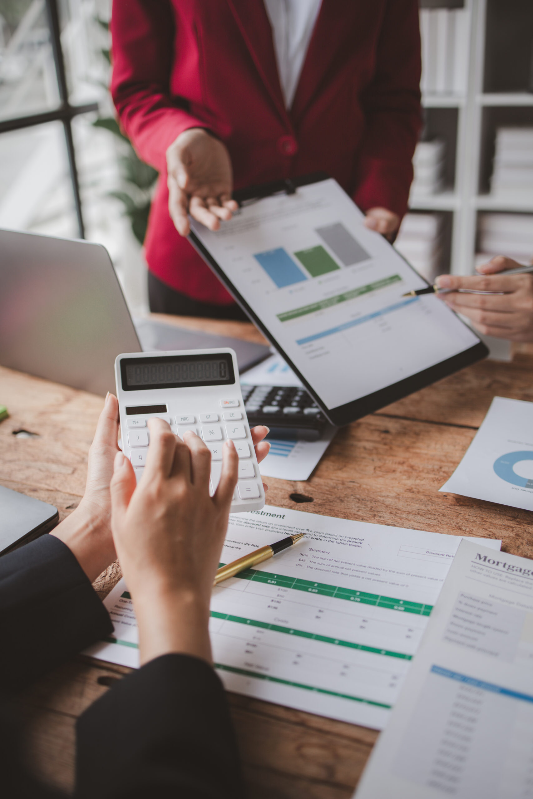 The sales department is having a monthly summary meeting to bring it to the department manager, they are verifying the correctness of the documents that are prepared before bringing in to the manager.